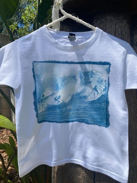 Handmade sun printed surfer t-shirt available as a babytee or regular fit for babytee please select "one size" (fits s/m) also available in regular sizes (s-xl) each shirt is made unique and not all will be the exactly the same but the print will be consistent  Wash instructions - Wash the fabric gently in cold water with a mild, pH-neutral detergent. Avoid using bleach or strong detergents, as they can degrade the print. -Avoid Direct Sunlight: Store the fabric away from direct sunlight when not in use. Prolonged exposure to strong light can cause fading over time. -Dry on cold setting or air dry. Surfer Concert Outfit, Plain Tee Shirts For Women, Sun Printing Shirt, Cloths Asthetic, T Shirt Aesthetic Outfits, Surf Shirts Graphic Tees, Sunprint Shirt, Cyanotype Shirts, Beach Shirt Ideas