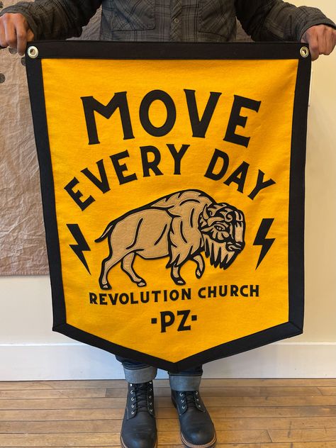 Move Every Day! Banner and pennant combo for @revolutionchurchga This banner features stitched felt lettering and bison. Each piece of the bison was stitched using our vintage chainstitch machine, adding to this banners unique one-of-a-kind look. #banner #banners #felt #moveeveryday #bestday #custombanner #custompennant #pennantbanner #collegiate #churchbanner #tradeshowbanner #eventbanner #churchdecor #churchinterior #campflag #feltbanner #tattoobanner #shopbanner #officedecor #studiodecor # Flag Design Ideas, Felt Lettering, Tattoo Banner, Tradeshow Banner, Custom Pennants, Felt Banner, Church Interior, Church Banners, Felt Letters