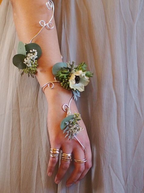 Bespoke wrist corsage, this design is created on soft flexible silver wire. White anemones, grey green eucalyptus and berries. Diy Corsage Wristlet Prom, Prom Flowers Corsage Green, Enchanted Forest Corsage, Arm Corsage Prom, Unique Prom Corsage Ideas Fresh Flowers, Unique Corsage And Boutonniere, Unique Wrist Corsage, Prom Wrist Corsage Ideas 2023, Unique Corsage Ideas