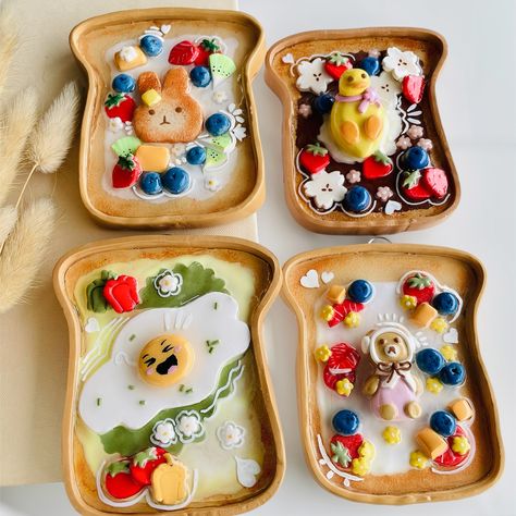 These cuties also coming to my shop tomorrow at 11:00 am EST! These adorable, food-themed trays are crafted in the shape of bread slices, and decorated with playful designs featuring characters like a bunny, a duck, and cute bears, along with colourful fruits and flowers. The intricate details, such as the blueberries, strawberries, and even a fried egg, create a cheerful and whimsical look that evokes the coziness of a fun breakfast. These trays can serve as versatile pieces, functioning a... Handmade Wall Hanging, Polymer Clay Figures, Small White Flowers, Colorful Fruit, Scene Design, Clay Figures, Fried Egg, Best Breakfast, Playful Design