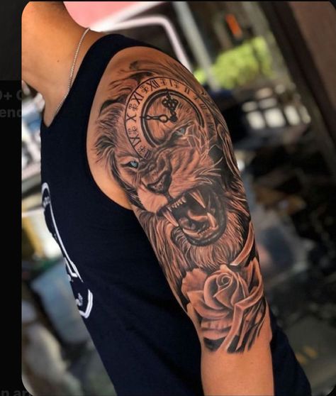 Cover Up Tattoos Half Sleeves, Lion Cross Clock Tattoo, Top Of Shoulder Tattoo Men, Lion Tattoo Half Sleeve, Black Men Shoulder Tattoo, Lion Tattoo Men, Lion Shoulder Tattoo, Animal Tattoos For Men, Lion Tattoo Sleeves