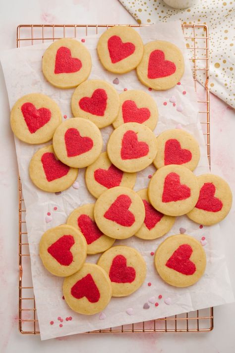 white cookies with red hearts in the middle spread out on parchment paper and cooling rack Heart Cut Out Cookies, Valentines Picnic, Valentines Day Cookie Recipe, Slice And Bake Cookies, White Cookies, Heart Sugar Cookie, Valentine Sugar Cookies, White Cookie, Rolled Sugar Cookies