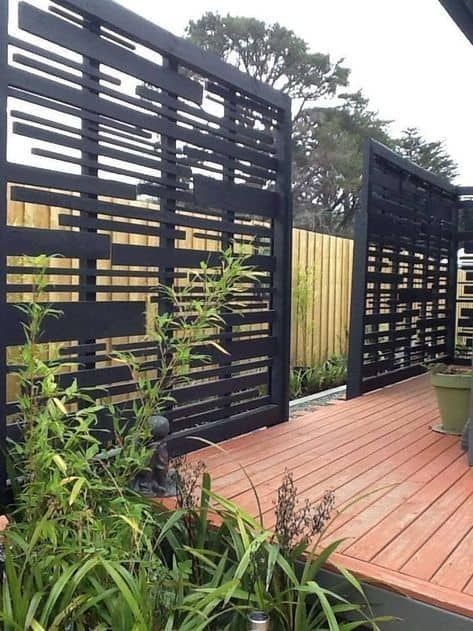 Having a patio or backyard is a fantastic feeling, especially on those warm summer days and cool evenings. However, some people may have the issue of ... | Go for a Stunning Black Statement Wall Gate With Vines, Modular Fence Panels, Inexpensive Privacy Fence Ideas, Pagar Modern, Backyard Privacy Screen, Yard Privacy, Patio Privacy Screen, Black Fence, Patio Privacy