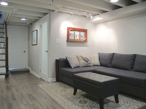 Finished small and shallow basement - Tiled floors, exposed beams painted white, and BM pale oak paint. Chic Basement, White Basement, Small Basement Design, Basement Ceiling Options, Small Basement Remodel, Pale Oak, Basement Layout, Tiled Floors, Basement Reno