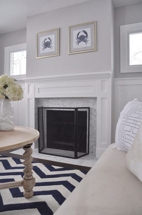 Benjamin Moore Stonington Gray with a marble fireplace surround with white mantel and wainscoting in a living room by Lindsay and Drew Fireplace With Gray Walls, Grey Marble Fireplace, Small Basement Remodeling, Painted Fireplace, White Mantel, Chevron Rug, Fireplace Tiles, Marble Fireplace Surround, Paint Fireplace