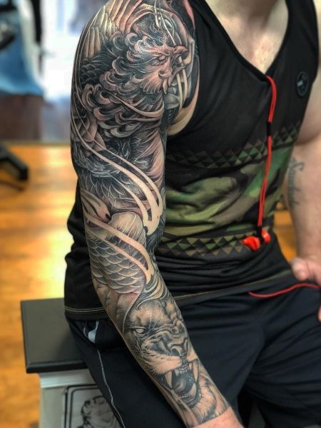 40 Poweful Phoenix Tattoos for Men (2024) - The Trend Spotter Phoenix Tattoo Men Sleeve, Phoenix Tattoo Design Men Forearm, Phoenix Forearm Tattoo, Phoenix Sleeve Tattoo, Phoenix Wings Tattoo, Phoenix Tattoo Men, Phoenix Tattoo Sleeve, Phoenix Feather Tattoos, Japanese Phoenix Tattoo