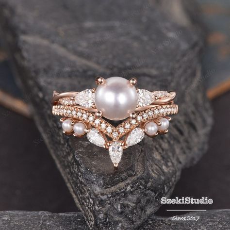 "Pearl Engagement Ring Set Rose Gold Infinity Diamond Ring Akoya Pearl Diamond Wedding June Birthstone Matching Band 2 Rings Set Bridal Set ITEM INFORMATION Metal Type - Solid 14k Rose Gold Band Width - (approx. 2.3mm) **Engagement Ring** Center Stone - 7mm Natural Akoya Pearl Side Stone -  moissanite Weight - 0.36 mm Clarity - SI Color -  H **Wedding Band** Stone -  moissanite and pearl Weight - 0.35mm Clarity - SI Color -  H **Stone Replacement** Available with any other gemstones, please feel free to contact me for a quote. **Metal Type** Available in 14K or 18K yellow gold, white gold, and rose gold. Please select from the drop down menu. **Production Time& Rush Order** Our standard production time is 3-4 weeks from time of purchase. I am very happy to provide rush order service, the p Vintage Pearl Ring Engagement, Wedding Rings Pearl Diamond, Pearl Engagement Ring Gold, Diamond Pearl Engagement Ring, Vintage Engagement Rings Pearl, Engagement Rings With Pearls, Diamond And Pearl Engagement Ring, Pearl Wedding Ring Set, Pearl Wedding Rings