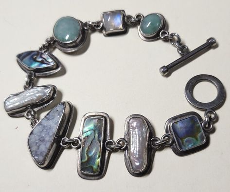 Tabra Tunoa: sterling silver "treasure" bracelet with quartz, moonstone, paua/abalone shell, druzy, and pearl (asking US $205.14 on eBay, February 2023) Abalone Shell Jewelry, Vintage Spoon Jewelry, Abalone Shell Bracelet, Taxidermy Jewelry, Silversmithing Jewelry, Silver Jewlery, Cool Piercings, Spoon Jewelry, Piercings Jewelry