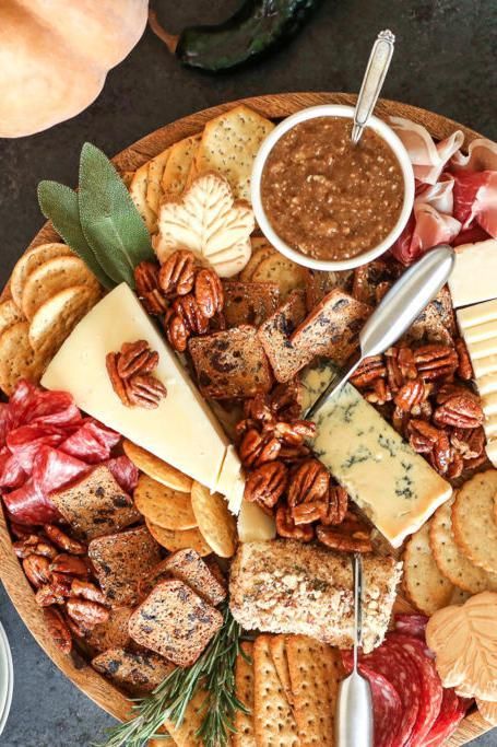 This pecan-packed charcuterie board balances warm, nutty flavors with tangy goat cheese, sweet maple and honey, and fresh herbs.Recipe couresty of American Pecans. Fall Charcuterie Board Ideas, Rosemary Pecans, Thanksgiving Charcuterie Board, Fall Charcuterie Board, Thanksgiving Charcuterie, Fall Charcuterie, Cheese Log, Charcuterie Board Ideas, Cinnamon Pecans