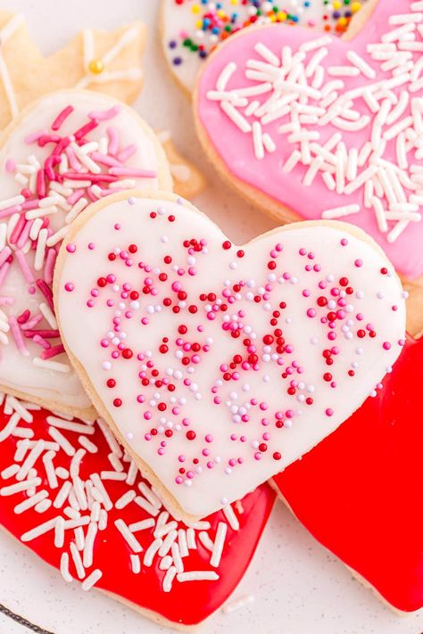 a couple of heart-shaped cut out sugar cookies with sprinkle. Sugar Cookie Heart Designs, Soft Cut Out Sugar Cookies, Homemade Sugar Cookies Recipe, Cookie Heart, Heart Sugar Cookies, Heart Shaped Sugar Cookies, Cut Out Sugar Cookies, Sugar Cookie Icing Recipe, Sugar Cookies With Sprinkles