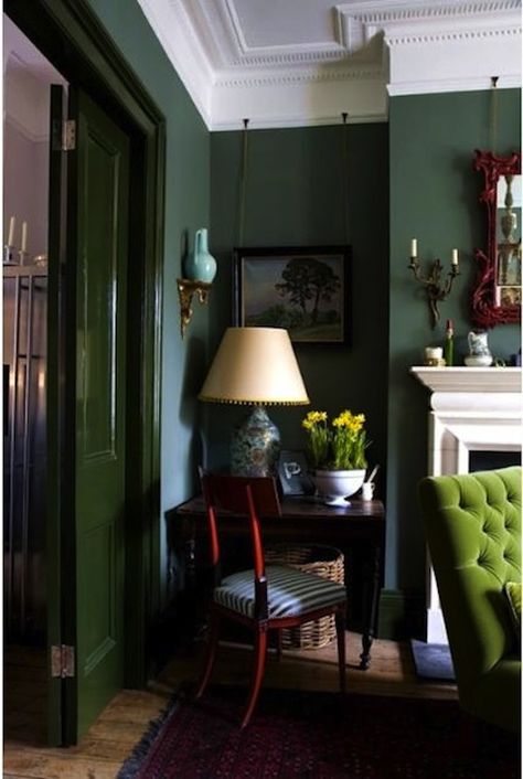 dark green walls with lime green tufted chair & great fireplace. I just don't like that the doors are painted a totally different green; it's too much! Bohemian Jungle Living Room, House Paints, Green Monochromatic, Green Walls Living Room, Dark Green Walls, Future Room, Green Walls, Dark Walls, Dark Interiors