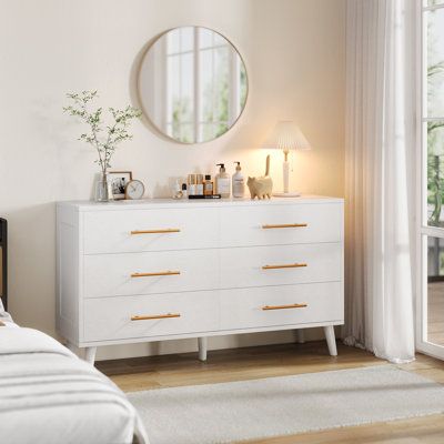 This versatile 6-drawer dresser, designed to elevate your bedroom with modern style and ample storage. This chest of drawers features sleek metal handles and a crisp white finish, making it a perfect addition to bedrooms, nurseries, living rooms, or entryways. With its thoughtfully crafted wood construction, this dresser blends functionality with contemporary elegance, providing the ideal solution for organizing your essentials in any space. Color: White | Mercer41 Dreggors 6 - Drawer Dresser 30 Teen Bedroom White Furniture, White And Gold Bedroom Dressers, White Dresser And Nightstand Set, White Dresser With Gold Knobs, Aesthetic Dressers Bedroom, Dresser White And Wood, Dresser With Mirror Decor Bedroom, Dresser Decorating Ideas, White And Gold Room