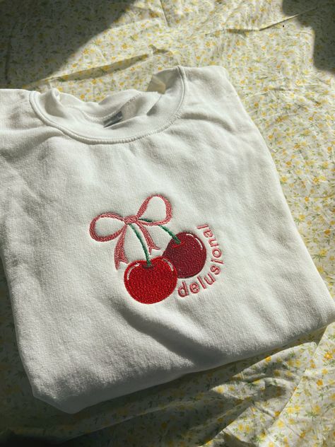 A white crewneck with a 3x5 cherry with a pink bow with the words delusional in pink. Cherry Gift Ideas, Etsy Sweatshirts, Cherry Sweater, Embroidered Jumper, Bow Top, White Crewneck, Fun Sweatshirts, For Her Gifts, Custom Sweatshirts