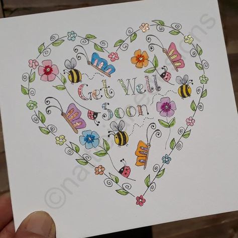 This is an original hand drawn,hand painted,hand lettered watercolour card. Features a pretty heart filled with pretty delicate flowers,butterflies,bees and ladybirds around the words get well soon. The smaller outer flowers are done with sakura glitter pens so they sparkle. The center of the Get Well Soon Cards Diy Watercolor, Get Well Soon Painting Ideas, Watercolour Get Well Soon Cards, Get Well Watercolor Cards, Hand Drawn Greeting Cards, Handmade Get Well Soon Cards, Get Well Soon Card Ideas, Get Well Soon Cards, Baby's First Christmas Card