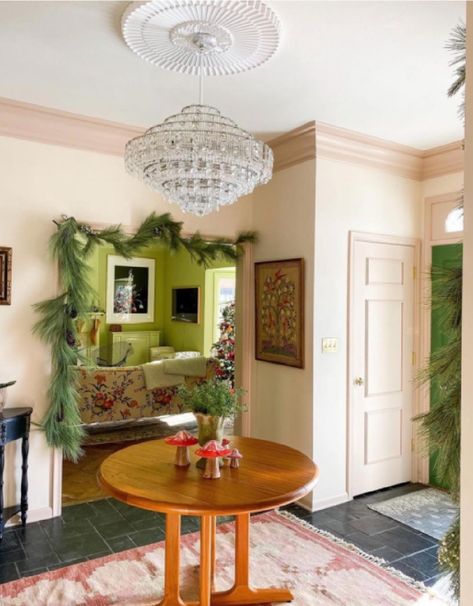 A glorious pink foyer with a magnificent crystal chandelier is decorated for the holidays - @witanddelight. #pinkrooms #classicinteriors #palepink Subtle Pink Paint, Pink Foyer, Blush Pink Paint, Pink Interior Design, Pink Interiors, Painted Trim, Pink Paint Colors, Colors Wallpaper, Pink Rooms