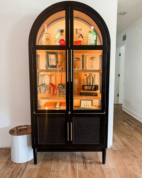 Comment SHOP below to receive a DM with the link to shop this post on my LTK ⬇ https://liketk.it/4Kq9E The Great Find!! It was a normal Sam’s Club run day when I came across this beautiful cabinet and I knew immediately I had to have it. I wanted to replace our open bar cart with this cabinet. I knew it would elevate the space! We added lights and wine glass holders to complete its look as a bar cabinet. It’s perfect and I am in love! It completely changed the look of the space, whic... Wine Glass Cabinet Display, Home Bar Display Liquor Cabinet, Arch Bar Cabinet, Tall Corner Cabinet Living Rooms, Bar Bookcase Ideas, Wine Glass Cabinet Ideas, Bar Cart Cabinet Ideas, Black And Gold China Cabinet, Small Drinks Cabinet Ideas