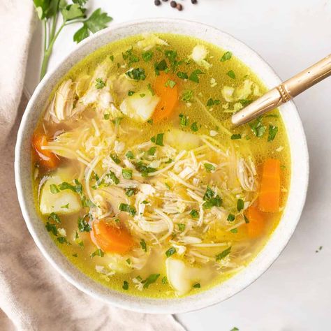 This traditional Spanish chicken soup recipe (sopa de pollo con fideos), it's the ultimate comforting meal that is nourishing, hearty, and delicious. Filled with a rich and aromatic broth, tender chicken, and vegetables, it's ideal for the cooler months, and makes the perfect remedy for sick days. This classic family recipe has been passed through generations, and it's a staple at home. Chicken And Fideo Soup, Dominican Chicken Soup Recipes, Spanish Chicken Soup Recipes, Spanish Chicken Soup, Vegetable Paella Recipe, Chicken Breast Soup, Pollo Recipe, Spanish Chicken, Homemade Chicken Stock