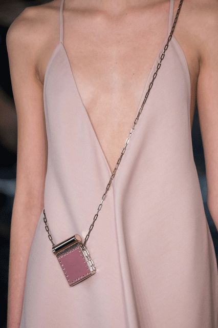 Micro Bags Are Getting Smaller & Smaller #refinery29  http://www.refinery29.com/2016/10/125135/valentino-baby-bags-pfw-spring-2017#slide-6  Stick to a solid color...... Micro Bags Street Style, Modern Pouch Shoulder Bag With Chain Strap, Modern Pink Pouch Shoulder Bag, Chic Pink Compact Bag, Micro Purse, Pink Runway Purse, Micro Bags, Micro Bag, Dress Bag