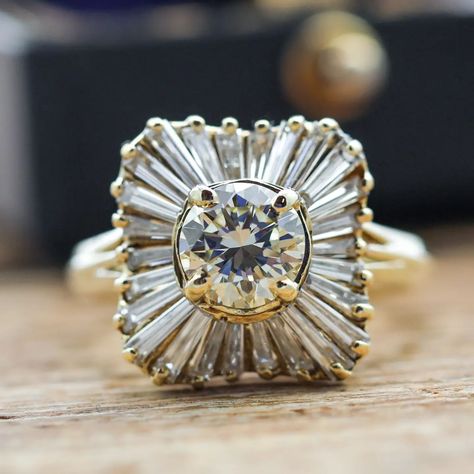 This ring centers a round brilliant cut diamond (1.05ct apx, N-O, VS2) set in 18k yellow gold with a halo of 26 tapered baguette cut diamonds (1.00ctw apx, K-L, VS) – sku: 130-08695 . . . . . . . #vintagejewelry #diamondring #engagementring #showmeyourrings #theknotrings Baguette Halo, Baguette Ring, Anniversary Gifts For Wife, Baguette Cut Diamond, Baguette Cut, Round Brilliant Cut Diamond, Cluster Ring, Moissanite Engagement Ring, Moissanite Engagement