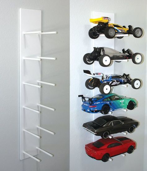 Here’s a car rack that’s easy on the eyes and the budget. All you need is 48 x 8″ pre-finished shelf and two 48 x 5/8″ dowels. Diy Toy Storage, Truck Storage, Cars Room, Rc Cars And Trucks, Playroom Organization, Rc Autos, Hobby Room, Car Racks, Rc Auto