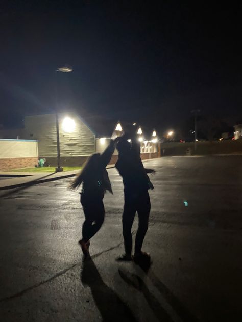 Dancing under a streetlight in a parking lot Dancing Under A Streetlight Aesthetic, Best Friends Parking Lot Pictures, Couple In Park At Night, Couple Under Street Light, Slow Dance In A Parking Lot, Parking Lots At Night, Dancing Night Aesthetic, Dark Parking Lot Photoshoot, Couple Parking Lot Pictures