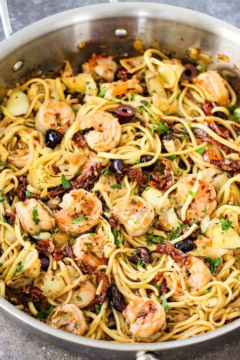 A large silver saucepan filled with Mediterranean pasta with shrimp. Pasta Recipes With Shrimp, Mediterranean Pasta Recipes, Mediterranean Shrimp Pasta, Recipes With Shrimp, Mediterranean Shrimp, Pasta With Shrimp, Mediterranean Recipes Healthy, Mediterranean Diet Recipes Dinners, Mediterranean Pasta