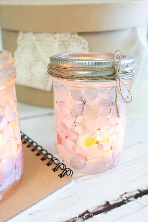 Add some romance to your space with pretty DIY mason jar luminaries made simply with pressed hydrangea blooms. Make Candle Holders, Pressed Hydrangea, Luminary Diy, Make Candle, Easy Mason Jar Crafts, Craft Spring, Jar Flowers, Mason Jar Luminaries, Jennifer Maker