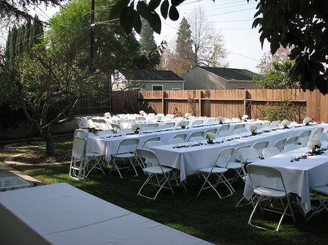 Simple long tables with folding chairs make perfect reception seating for a backyard vow renewal Graduation Seating Ideas, Graduation Party Seating Ideas, Backyard Party Set Up Ideas Layout, Backyard Party Seating, Backyard Party Setup, Backyard Graduation Party, Backyard Wedding Decorations, Outdoor Graduation Parties, Outdoor Graduation