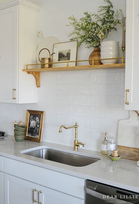 Kitchen Over Sink Shelf, Kitchen Sink On Interior Wall, Wooden Shelves Above Kitchen Sink, Kitchen Sink Against Wall With No Window, Kitchen Sinks No Window, Glass Shelf Over Kitchen Sink, Open Shelving By Sink, Sink Not In Front Of Window, Kitchen Sink Upper Cabinet Ideas