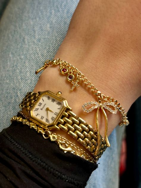 Charm bracelet Bow charm Gold watch Gold charms Gold Watch Jewelry, Gold Jewelry Stacking, Golden Bracelet Stack, Shop The Deli Jewelry, Chunky Gold Bracelet Stack, Cute Gold Watch, Gold Jewelry Stack Bracelet, Gold Bracelet Stack With Watch, Jewelry Stack Gold