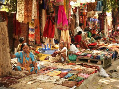 In a matter of 15 minutes a deserted road facing the capital's Indira Gandhi Stadium complex comes alive with a colourful ensemble of clothing and other utilities. Street vendors gather here every Sunday to set up a bazaar which its promoters say could serve as a global model. - Firstpost Bazaar Aesthetic, Aesthetic Assignment Ideas, Indian Bazaar, India Places, Bangles Shop, Chris Morris, Indira Gandhi, Street Vendor, India Tour