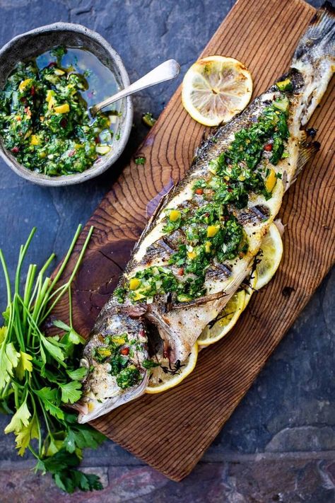 How to grill a whole fish (Branzino) topped with the most flavorful Preserved Lemon Gremolata, (Zesty Herb Sauce) in about 30 minutes flat! A simple easy Mediterranean dinner! #branzino #grilledfish #wholefish #grilledbranzino Lemon Gremolata, Branzino Recipe, Whole Fish Recipes, Gremolata Recipe, Mediterranean Dinner, Feasting At Home, Clean Eating Guide, Preserved Lemon, Herb Sauce