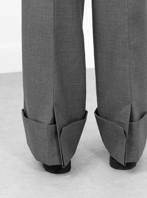 The Ox Pants from TOGA PULLA arrive in a grey. Made in Japan from a woollen blend, the mid-rise trousers fall to a relaxed fit with a voluminous taper. Front pleats and turn-ups at the cuff give the trousers their shape. A rear welt pocket and patch pocket sit below a shiny fabric detailing at the back of the trousers.  Fit:   Relaxed fit  Voluminous finish  Model is 5'9.5" and wears a S   Details:  Mid-rise trousers Belt loop  Front pleats  Rear fabric detail  Rear welt pocket and patch pocket  Turn ups  70% Polyester/30% Wool  COO: Japan  Colour: Grey . Department: Trousers , TOGA PULLA , Size: XS Modern Trousers With Hip Pockets, Luxury Trousers With Side Pockets, Tailored Gray Trousers, Luxury Gray Trousers, Gray Wool Trousers, Clothes Details, Pleats Fashion, Fabric Detailing, Toga Pulla