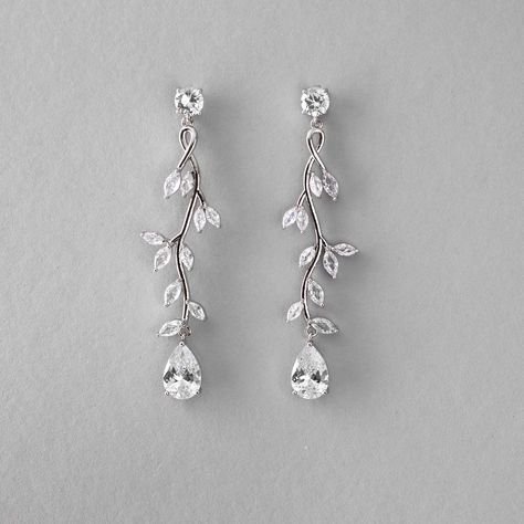 Create a stunning bridal look with our Long Vine CZ Wedding Earrings. These earrings are delicately crafted with a vine of marquise leaves featuring a single pear-cut CZ stone, that adds a touch of elegance to any wedding ensemble. They are about 2.5 inches long, rhodium or gold plated, made with AAA CZ stones, and lead, nickel, and cadmium free. Modern Wedding Earrings Bridal, Fall Wedding Earrings, Dangle Wedding Earrings, Silver Wedding Earrings, Icicle Earrings, Dangly Earrings Silver, Wedding Earrings Bride, Fall Wedding Jewelry, Spring Ball