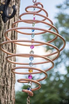 How to Make Coiled Copper Wind Chimes                                                                                                                                                                                 More Wind Chimes Diy, Copper Wind Chimes, Glass Bottle Diy Projects, Copper Wind Spinners, Chimes Diy, Copper Wire Crafts, Diy Copper, Glass Bottle Diy, Diy Wind Chimes