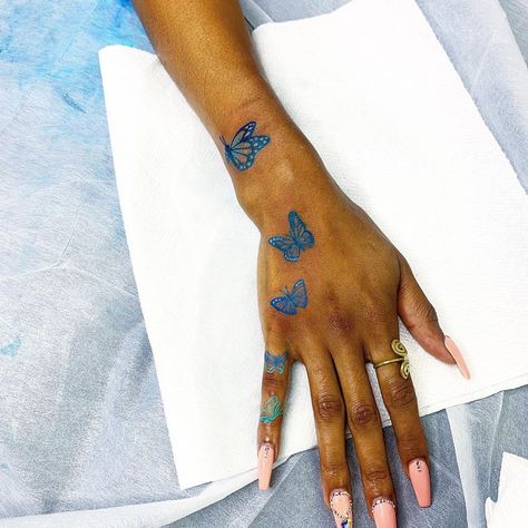 Blue Butterfly Tattoo Black Women, Blue Tattoo Ink On Brown Skin, White Butterfly Tattoo On Dark Skin, Blue Tattoos On Brown Skin, Blue Tattoos For Women Brown Skin, Blue Ink Tattoos Black Women, Purple Tattoo On Dark Skin, Blue Tattoo On Brown Skin, Tattoo On Brown Skin