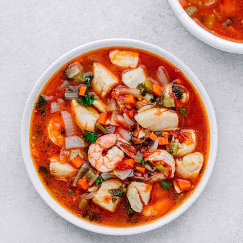 It tastes delicious and easy! This hearty fish soup is packed with flavor. An easy seafood stew recipe that can be ready and on your dinner table in less than 30 minutes. The soup is filled with cod fillets, shrimp, mixed vegetables in a rich tomato broth. #fishsoup #fishstew #seafoodsoup #seafoodstew #whitefish #shrimp #cod #soup Mixed Seafood Soup, Cod Soup, Fish Soup Recipe, Mixed Seafood, Seafood Stew Recipes, Fish Stew Recipes, Cod Fillets, Tuna Fillet, Tomato Broth