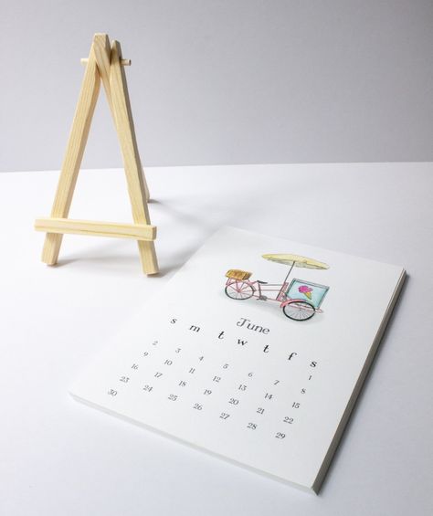 This 2024 desk calendar doubles as a piece of art for your home or office. Each month features a hand designed watercolor painting. Perfect for a 5x7 frame, to hang on a corkboard or fridge. These make great gifts for friends, family, neighbors, teachers, and more. Each month is 5x7 and are printed on smooth, thick 120 lb paper. Optional add on - Wooden easel. Wooden stand is a natural wood color and able to hold all 12 pages at once 5x7 Frame, Wooden Easel, Desk Calendar, Calendar 2024, Art For Your Home, Desk Calendars, Cork Board, Wooden Stand, Wood Color