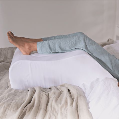 A leg pillow to provide relief from Swollen Ankles, Phlebitis, Oedema and Varicose Veins. The leg support wedge is available to buy online direct from P... Leg Rest Pillow, Leg Support Pillow, Tired Legs, Swollen Ankles, Bed Wedge, Knee Pillow, Leg Pillow, Bed Rest, Wedge Pillow