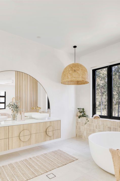 Breezy Mediterranean-inspired Queensland home, Casa Blanca Modern Mediterranean Laundry Room, Arch Mirror In Bathroom, Round Bathtub Ideas, House On Acreage, Pendant Over Bathtub, Timber Vanity Bathroom, Bathroom With Closet, Mediterranean House Interior Design, Coastal Boho Bathroom