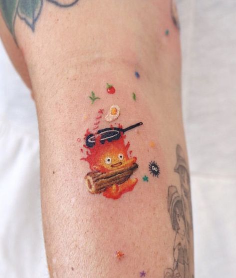 Ghibli Studio Tattoo Ideas, Calcifer And Soot Sprite Tattoo, Studio Ghibli Tattoo Calcifer, Studio Ghibli Calcifer Tattoo, Nostalgic Tattoos, Calcifer Tattoo, Dumbest Tattoos, Tatuaje Studio Ghibli, Ghibli Tattoos