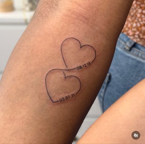 Fine line tattoos with connected hearts. Intertwined hearts with kids birth dates. Heart And Year Tattoo, Birth Year Heart Tattoo, Date Tattoo Ideas Behind Ear, Heart With Birthday Tattoo, 2 Dates Tattoo, Tattoos Dates Of Birth, Two Hearts Connected Tattoo, Tattoo Ideas Date Of Birth, Heart And Date Tattoos