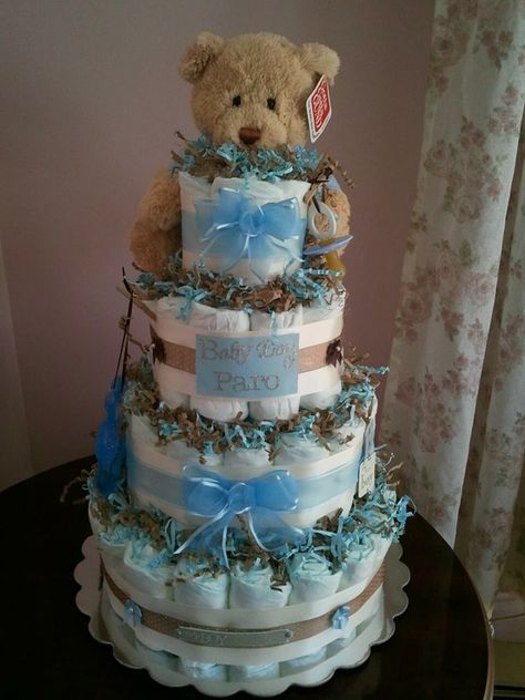 Baby boy diaper cake...you can't tell from the photo, but the teddy bear is wearing scrubs since the parents-to-be were two doctors :) Teddy Bear Diaper Cake, Bear Diaper Cake, Spa Robes, Baby Shower Table Centerpieces, Bear Baby Shower Theme, Diaper Cake Boy, Baby Shower Diaper Cake, Trendy Baby Shower Ideas