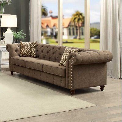 This Gerson 89.5" Linen Rolled Arm Chesterfield Sofa is detailed with classic details like deep button tufts and plush, sheltering arms. Adorned with button tufting and rolled arms with backs and included accent pillows, wood frame, and wooden turned-bun legs. Fabric: Brown | Everly Quinn Gerson 89.5" Linen Rolled Arm Chesterfield Sofa Linen in Brown, Size 30.0 H x 89.5 W x 33.0 D in | Wayfair Brown Chesterfield Sofa, Chesterfield Sofa Living Room, Sofa Linen, 3 Piece Living Room Set, Acme Furniture, Living Room Collections, Linen Sofa, Brown Sofa, Gerson