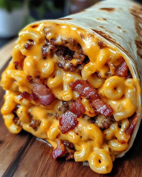 Bacon Macaroni Cheeseburger Wrap 🌯 Ingredients: - 1 lb ground beef - 2 cups cooked macaroni - 6 strips bacon, cooked and crumbled - 1 cup shredded cheddar cheese - 1/4 cup ketchup - 1/4 cup mustard - 4 large flour tortillas Instructions: 1. Cook the ground beef in a skillet over medium heat until browned, breaking it apart with a spoon. Drain excess fat. 2. Mix in the cooked macaroni, crumbled bacon, shredded cheddar cheese, ketchup, and mustard. Stir until well combined and the ch... Bacon Macaroni Cheeseburger Wrap, Recipe With Velveeta, Bacon Mac N Cheese Burger Wrap, Loaded Bacon Cheeseburger Tacos, Cheesy Bacon Burger Wraps, Bacon Mac And Cheese Burger Wrap, Bacon Cheeseburger Wraps, Morning Food Ideas, Lunch Healthy Ideas