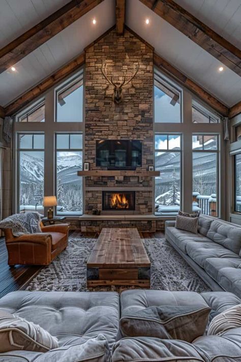 This living room captures the essence of a mountain lodge, featuring wooden beams and a stone fireplace. Fur rugs and antler decor add layers of warmth and rustic elegance. Embrace these rustic living room ideas for a home that's as inviting as a mountain retreat. Explore similar styles like ski chalet chic, alpine luxury, and rustic contemporary for your living space. Discover the full series of 16 mountain lodge inspired living rooms. Ski House Decor Interiors Rustic, Modern Ski House Living Room, Alpine Lodge Interior, Ski House Living Room Decor, Ski Living Room, Mountain House Interior Living Room, Chalet Home Decor, Mountain Style Living Room, Alpine Chic Interiors