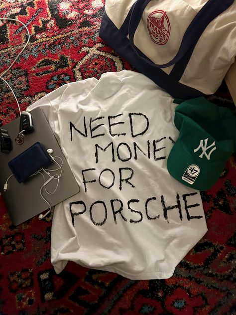 need money for porsche white t-shirt forest green baseball cap ny yankees blue Louis Vuitton wallet trader joes bag apple MacBook earbuds rug aesthetic Porsche Shirt, Need Money For Porsche, Need Money, Classic White, Fitness Inspo, Graphic Shirts, Mood Pics, Aesthetic Pictures, Dream Cars