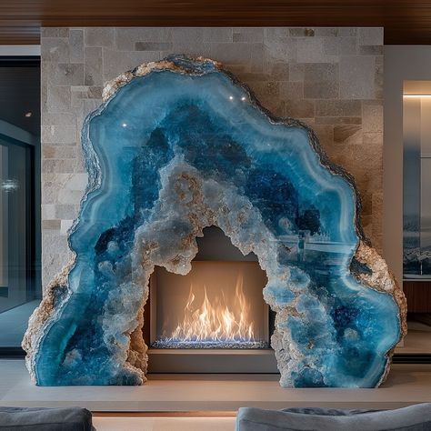 A geode fireplace is a stunning centerpiece that blends the natural beauty of geology with the warmth and comfort of a modern hearth. Crafted to mimic the intricate formations found inside geodes, the fireplace features a crystalline interior that shimmers with vibrant hues when illuminated by the flickering flames. The exterior is rugged and textured, resembling the raw outer shell of a geode, while the inside reveals a dazzling array of crystals, offering a captivating contrast. Perfect for... Geode Fireplace, Modern Hearth, Aqua Garden, Giant Crystal, Geode Decor, Blue Geode, Dreamy Room, Reno Ideas, Crystal Design