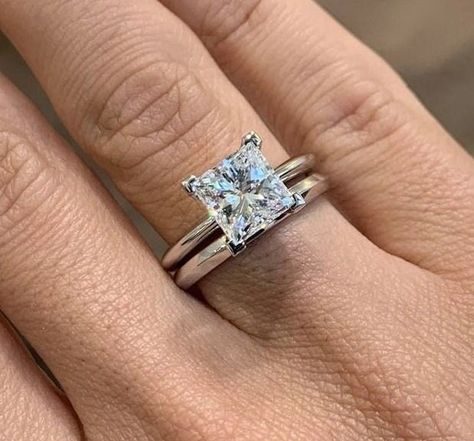 Celebrate your love and commitment with this exquisite Princess Cut Moissanite Wedding Ring Bridal Set. Expertly handcrafted, this set includes an engagement ring and a matching wedding band, designed to complement each other perfectly. The engagement ring features a mesmerizing princess cut Moissanite stone, known for its exceptional brilliance and fire. It is delicately set in a lustrous white gold band, accentuated by smaller, shimmering diamonds along the band. The matching wedding band is c Princess Cut Engagement Ring And Band, Platinum Princess Cut Engagement Ring, Princess Cut Engagement Ring With Band, Princess Cut Engagement Rings Gold, Set Wedding Rings, Solitaire Wedding Ring Set, Princess Cut Solitaire Ring, Engagement Ring Plain Band, Emerald Engagement Ring Set