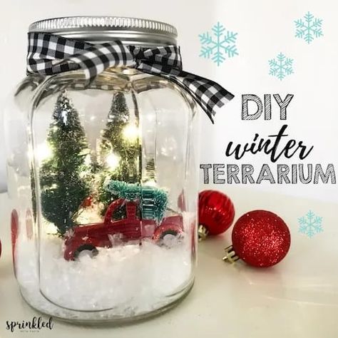 In this tutorial, I'm sharing how to make an easy, retro farmhouse-inspired light up winter terrarium that will be perfect for your Christmas decor. Winter Terrarium, Christmas Jars Decorations, Mason Jar Christmas Decorations, Christmas Lights Inside, Fairy Lights In A Jar, Christmas Fairy Garden, Mason Jar Christmas Crafts, Jar Projects, Xmas Centerpieces